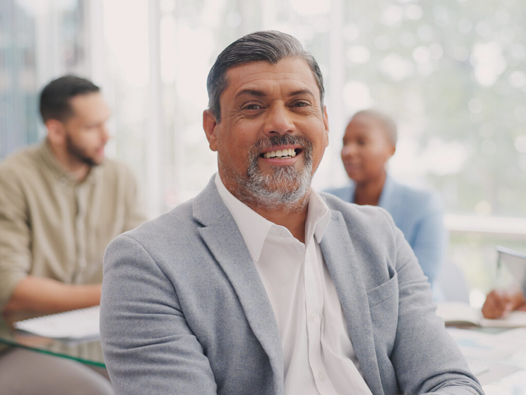 a smiling indian investor inquiring about eb5 visa for indian investors