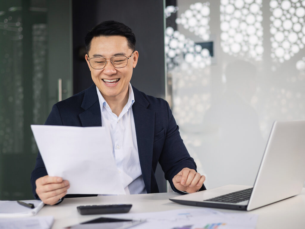 a man holds an EB-5 note, reviewing it for investor immigration