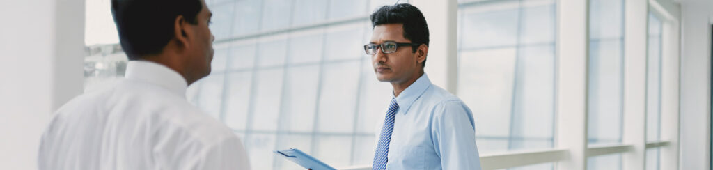 foreign investor discusses documents with someone from capital visa services