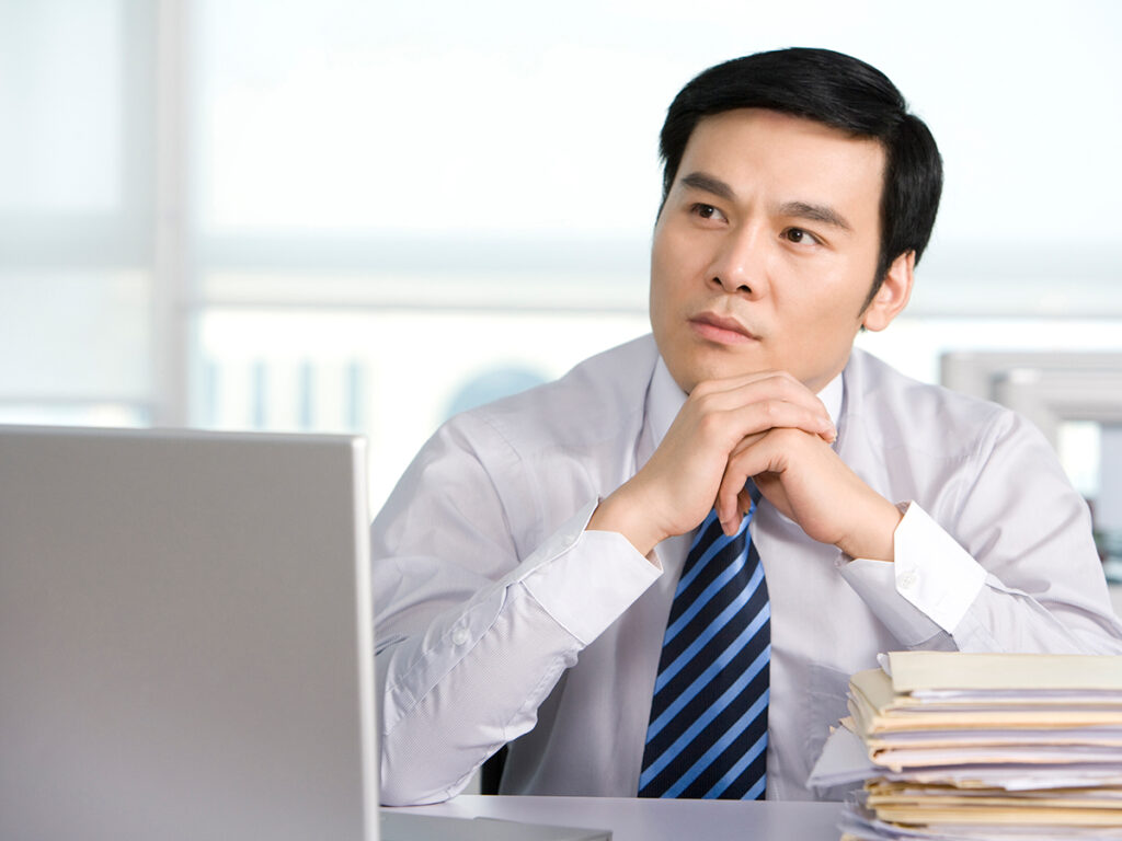 Asian investor contemplating how to spot eb5 fraud early on