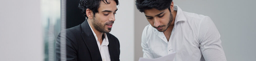 Two male foreign investors talking about eb5 delays and its causes