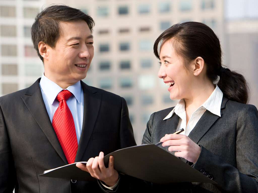 Asian investors reviewing documents while doing investment risk analysis